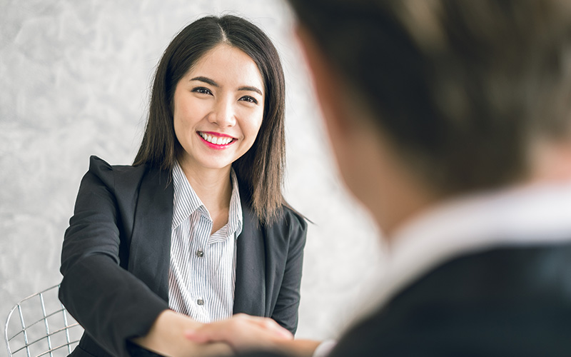 Businesswoman shaking hands with a colleague after a meeting.