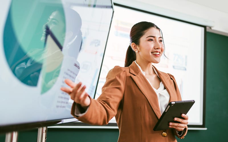 Woman giving a presentation at a business meeting.