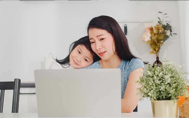 mother and daughter in front of a laptop