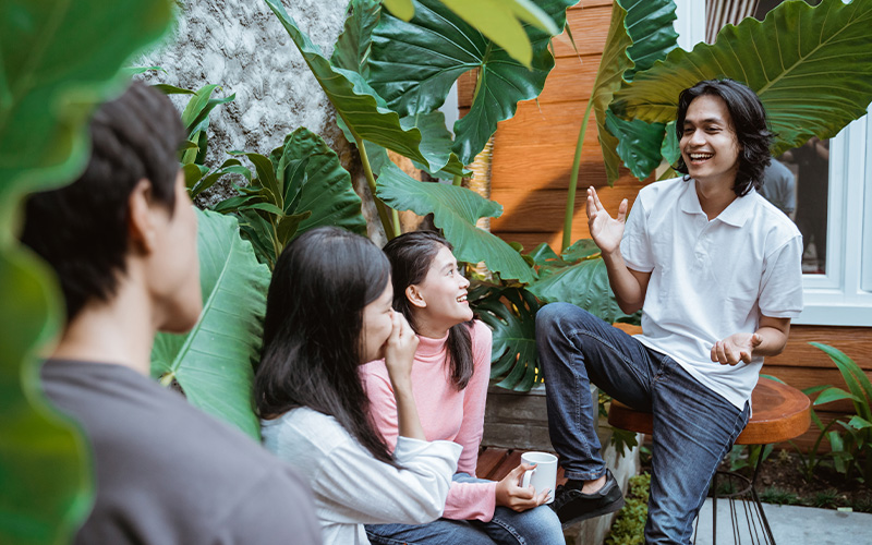 Friends chatting and laughing in a garden setting