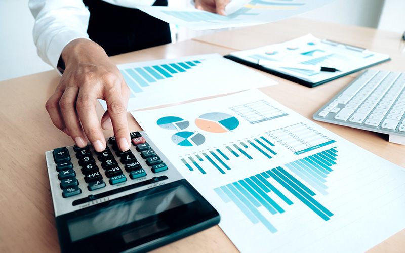 Accountant calculating expenses and analyzing financial data.